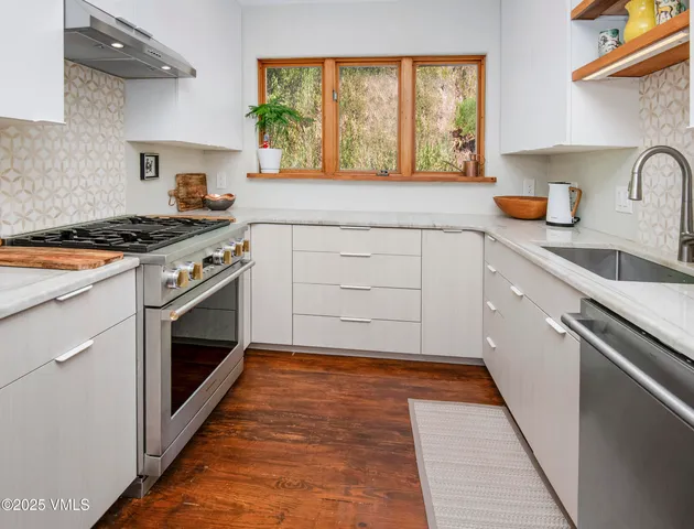 a stove top oven sitting inside of a kitchen
