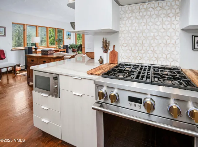 a living room with furniture a fireplace and a large window