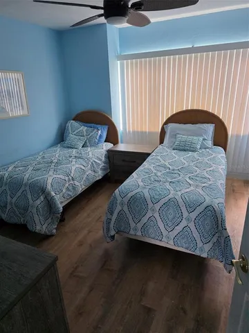 a bedroom with a bed lamp and window