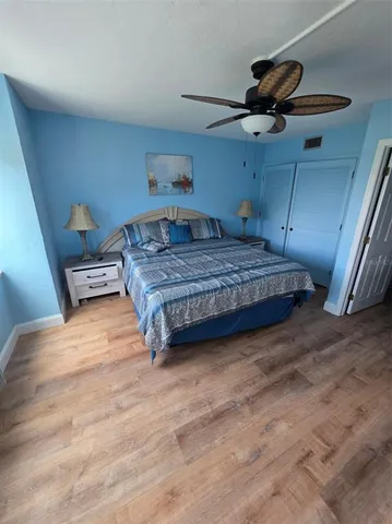 a bedroom with a bed and ceiling fan