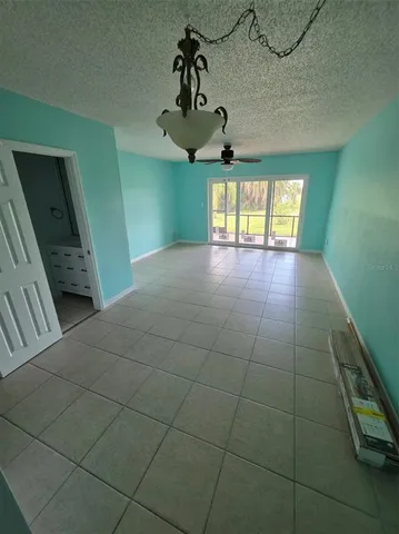 a view of a livingroom with a ceiling fan and window