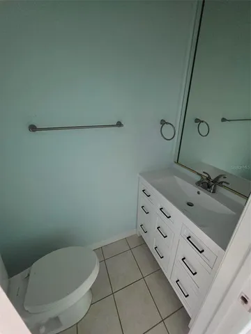 a bathroom with a sink a toilet and mirror