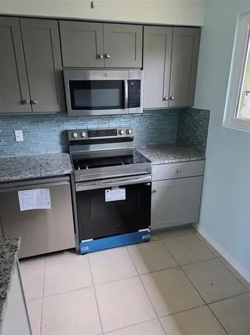 a kitchen with a stove and a microwave