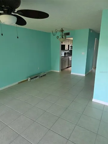 a view of a kitchen with fridge and window