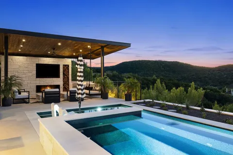 a view of swimming pool with outdoor seating and plants