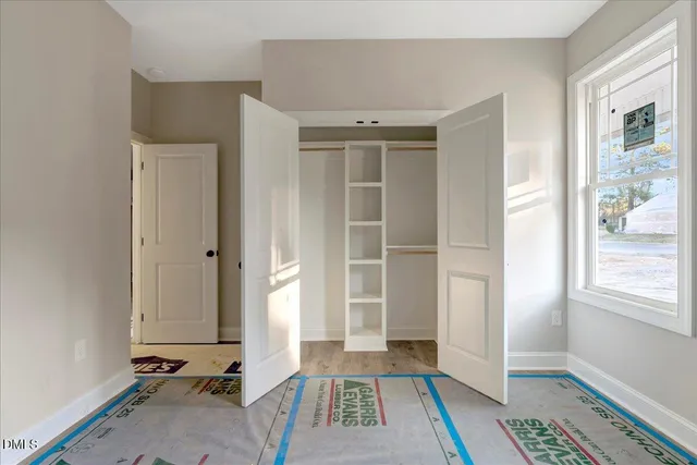 a view of bedroom with a bed and a window