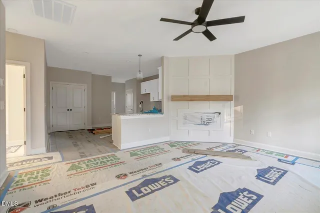 a view of a kitchen with wooden floor and a sink