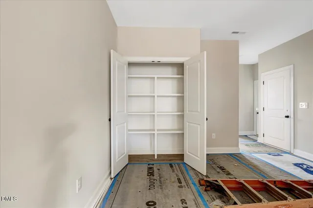 a area with wooden floor and cabinets