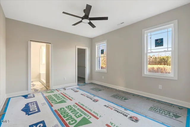 a view of a bedroom with bed and a window