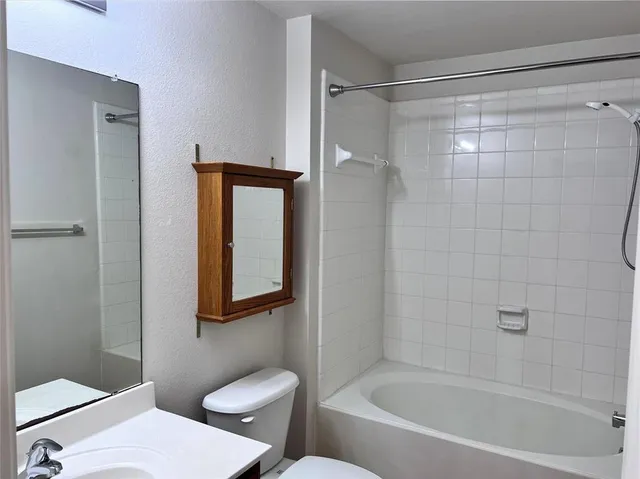 a bathroom with a toilet and a bathtub