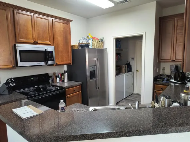 a kitchen with a refrigerator stove and microwave