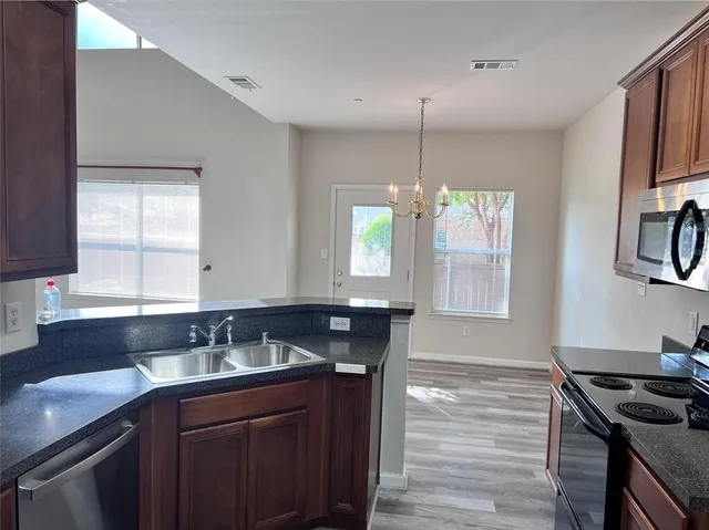 a kitchen with a sink stove and microwave