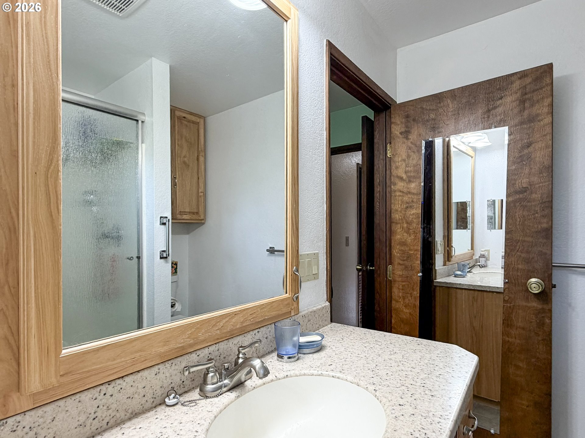 1372 Hampton Road Brookings, OR 97415 - Photo 28 of 42 a bathroom with a granite countertop sink and a mirror