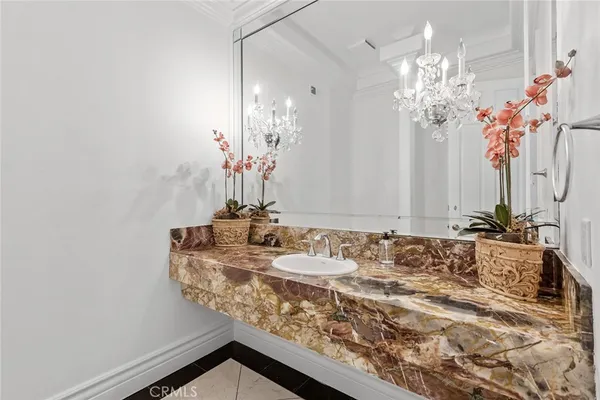 a bathroom with a granite countertop sink a large mirror and a shower