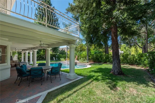 a view of a house with backyard and a sitting area