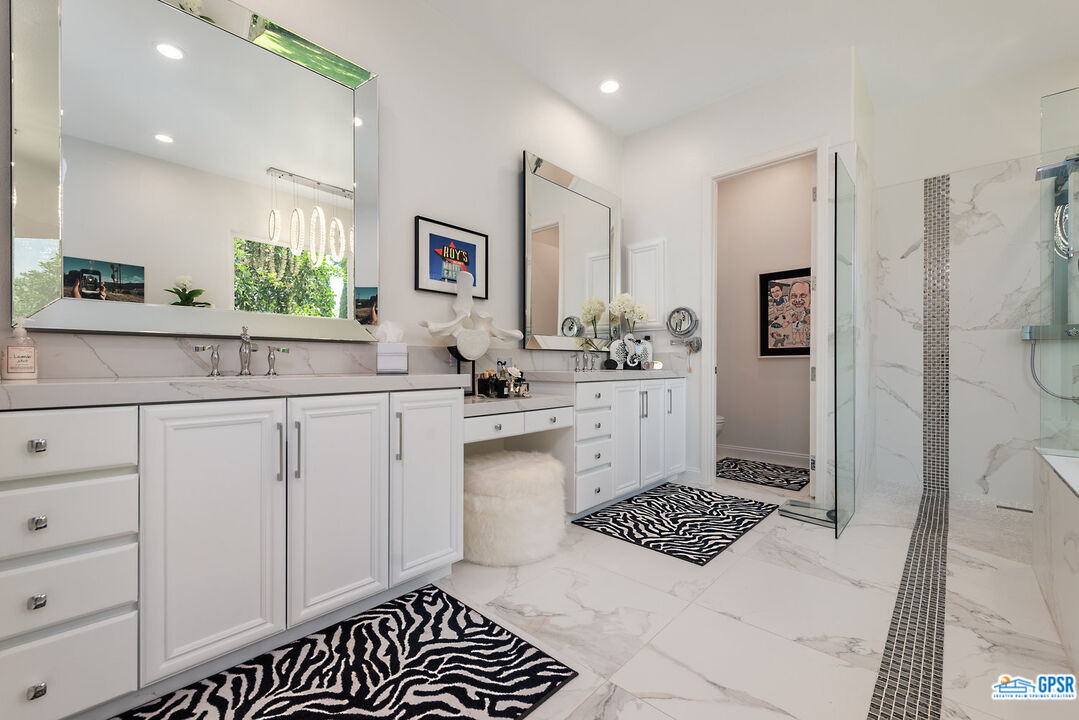 53 Vista Encantada Rancho Mirage, CA 92270 - Photo 16 of 33 a kitchen with a refrigerator sink and cabinets