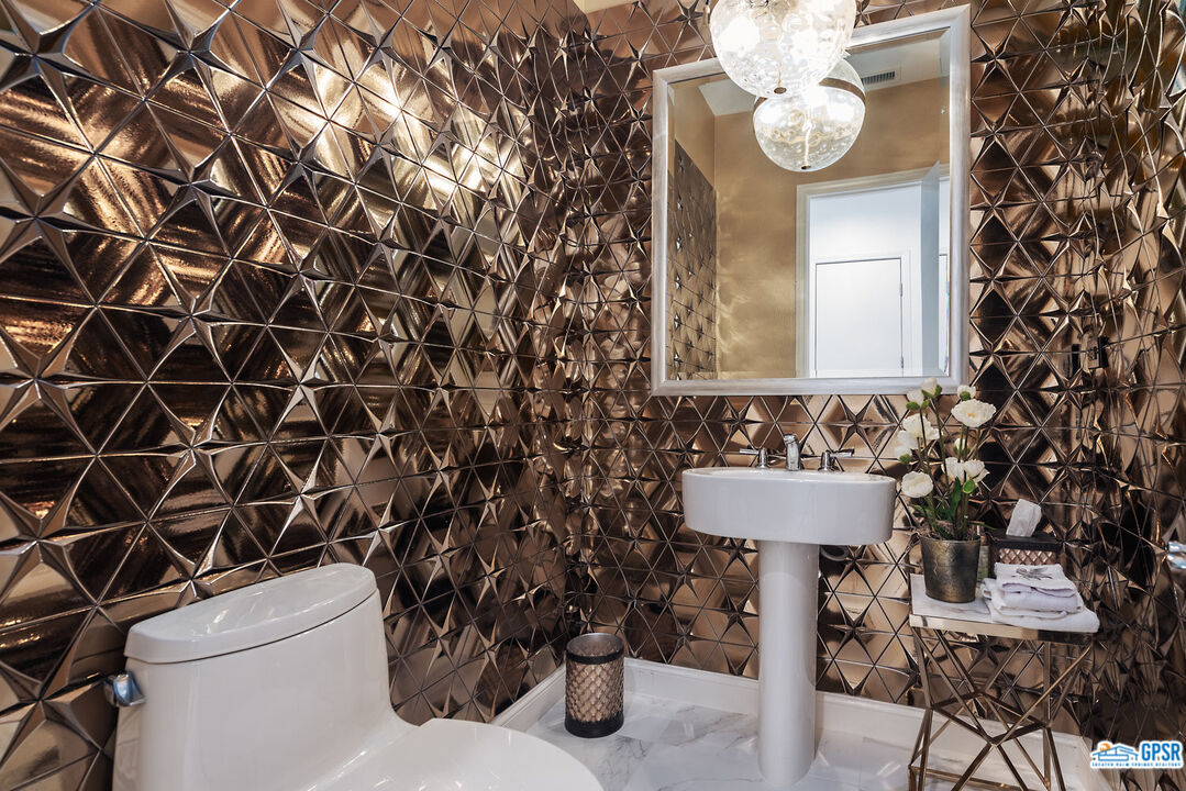 53 Vista Encantada Rancho Mirage, CA 92270 - Photo 9 of 33 a bathroom with a toilet sink and mirror