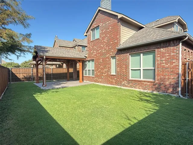 a view of a house with a yard and sitting area
