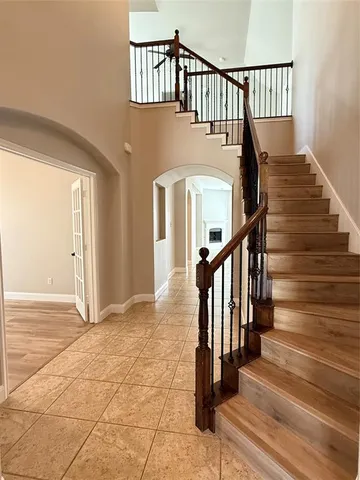 a view of staircase with lots of frames on wall and wooden floor