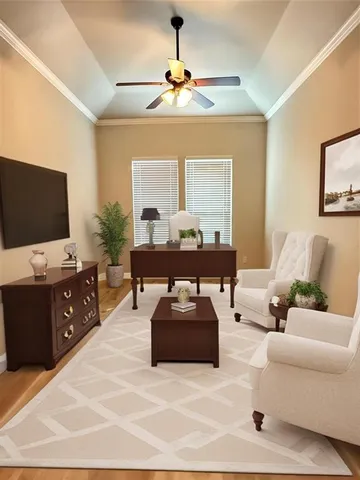 a living room with furniture and a flat screen tv