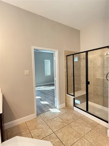 a view of a big room with sliding door and wooden floor