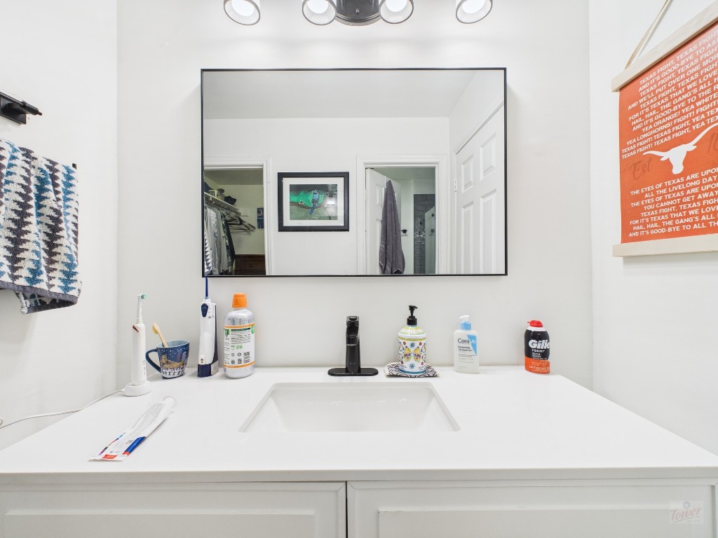 2529 Rio Grande Street, Unit 24 Austin, TX 78705 - Photo 12 of 15 a bathroom with a sink vanity and mirror