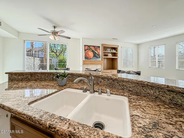 a bathroom with a granite countertop sink and a bathtub