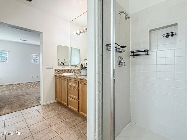 a bathroom with bathtub and next to a window