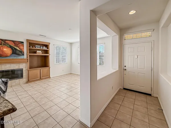 a view of a livingroom with an empty space and a fireplace
