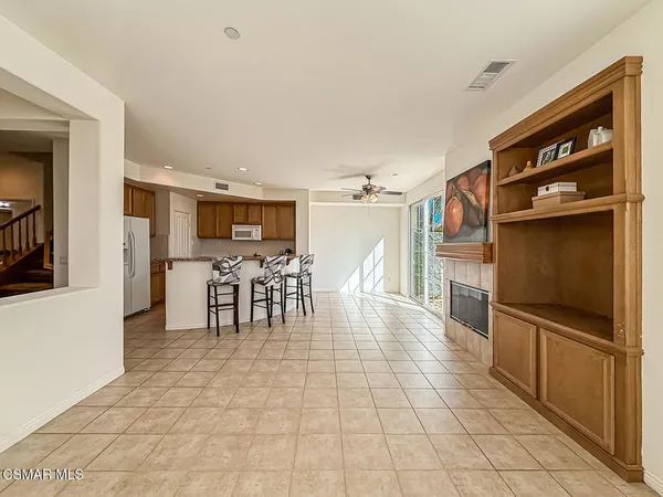 a dining hall with stainless steel appliances a dining table and chairs with wooden floor