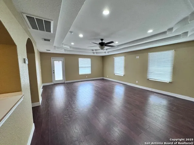 a view of a livingroom with wooden floor and window