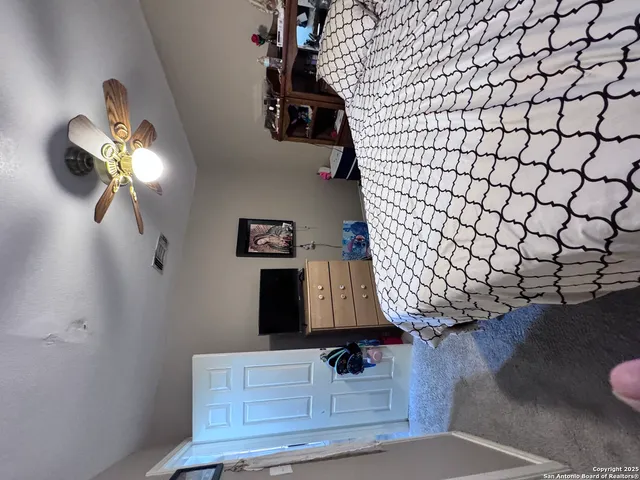 a bedroom with a bed and wall painting