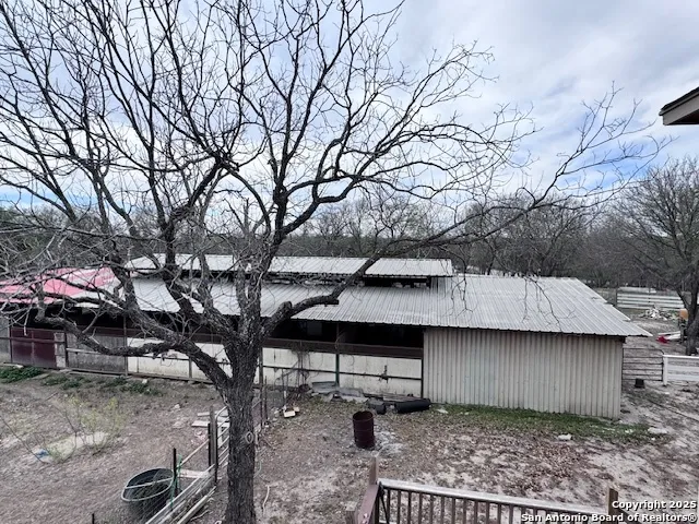 a backyard of a house with barbeque oven fire pit table and chairs