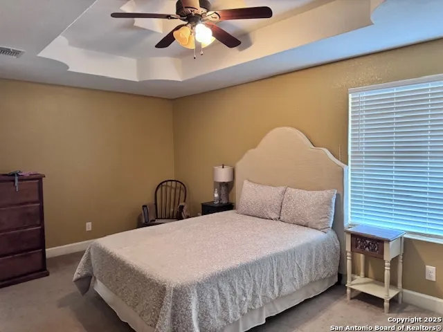 a bedroom with a bed and ceiling fan