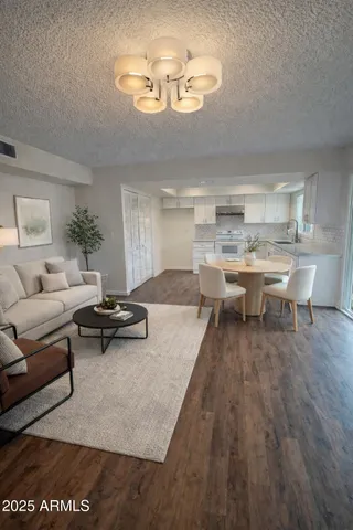 a living room with furniture and a chandelier