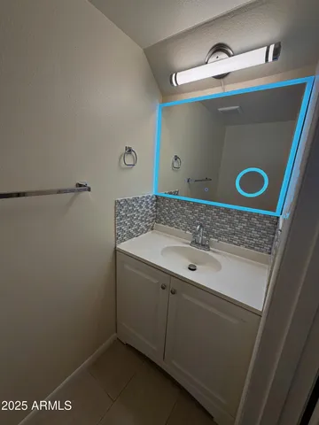 a bathroom with a sink and mirror