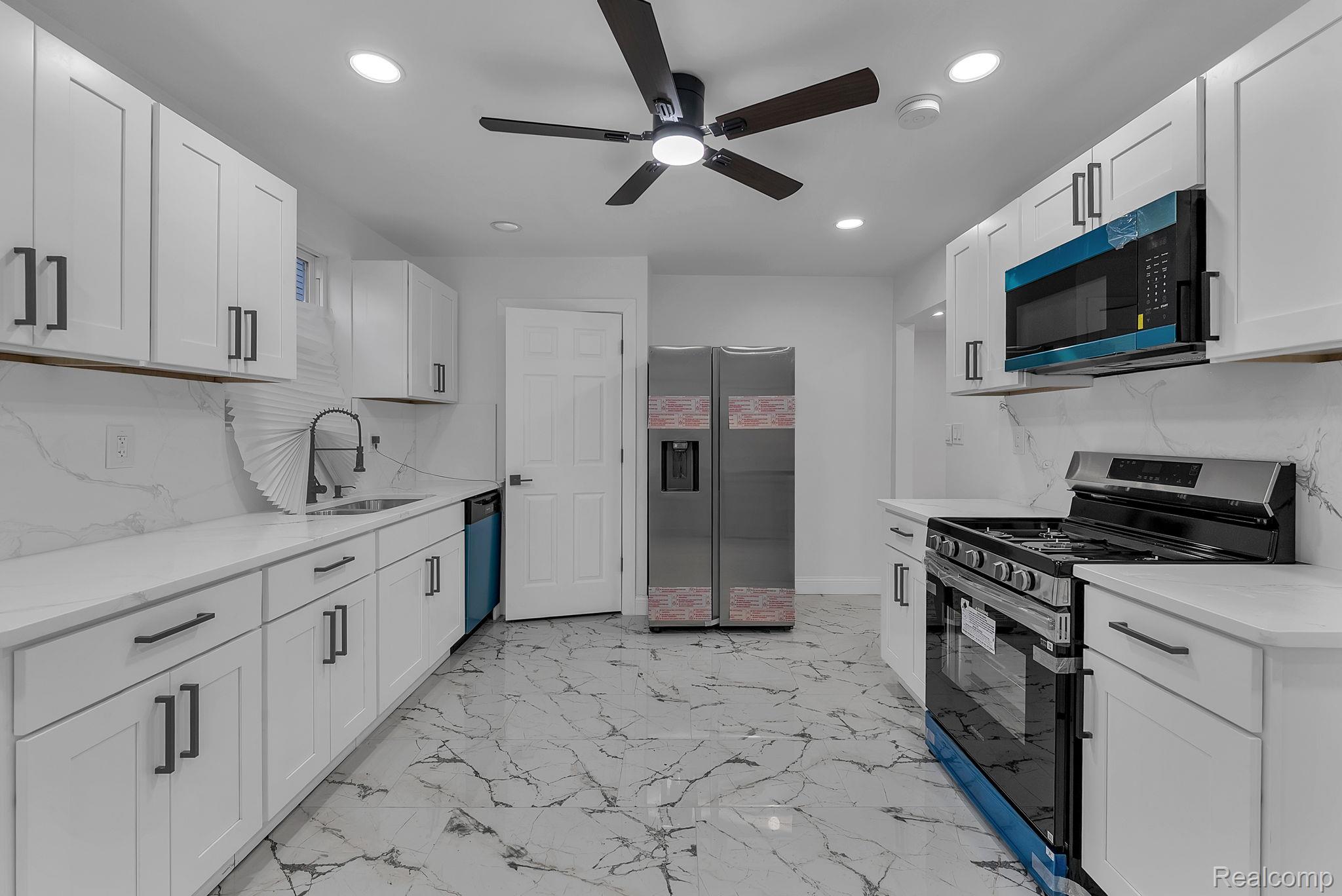 4113 Devonshire Road Detroit, MI 48224 - Photo 16 of 36 Kitchen featuring appliances with stainless steel finishes, white cabinetry, recessed lighting, ceiling fan, and light stone counters