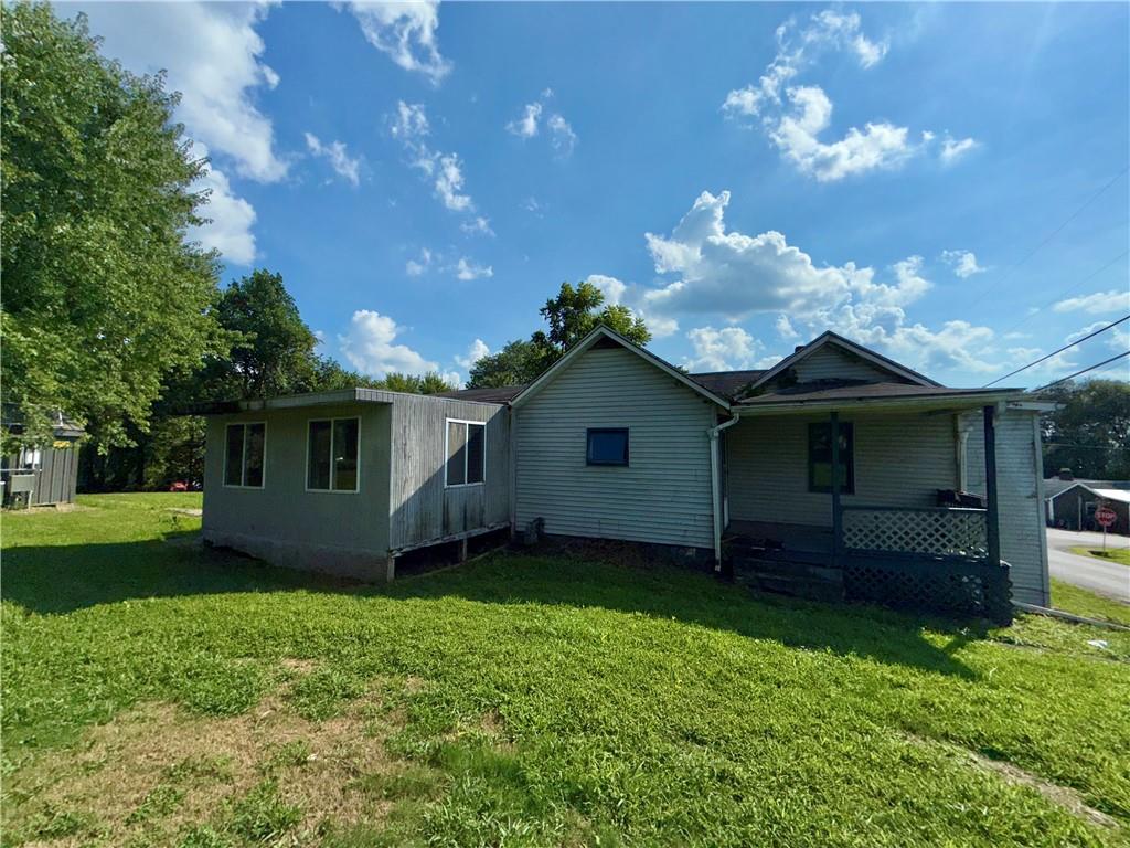 304 Narrows Road Connellsville, PA 15425 - Photo 4 of 13 a view of a backyard with potted plants and large tree