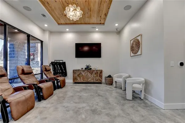 a living room with furniture a large window and gym equipment
