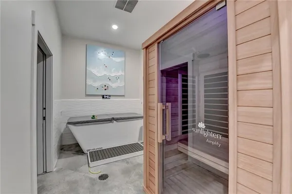 a bedroom with a bed and a chair