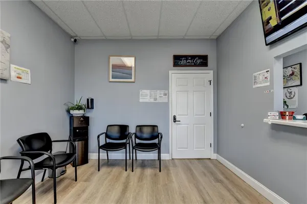 a living room with furniture and painting on the wall