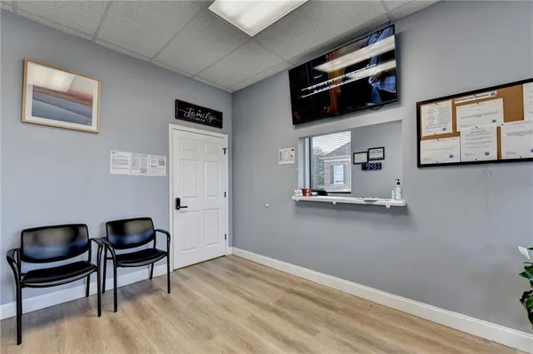 a living room with lots of furniture and clutter