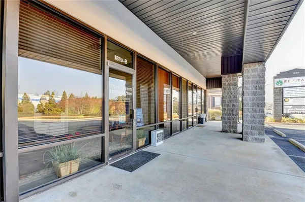 an empty room with floor to ceiling windows and pool table