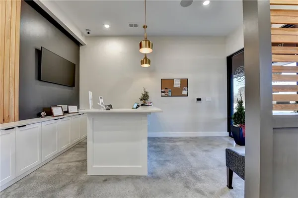 a view of kitchen with kitchen island a sink and wooden floor