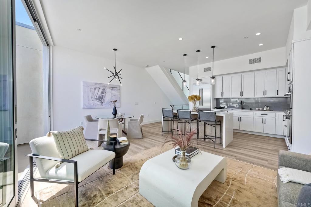2646 State Street, Unit D Carlsbad, CA 92008 - Photo 24 of 43 a living room with lots of furniture and kitchen view