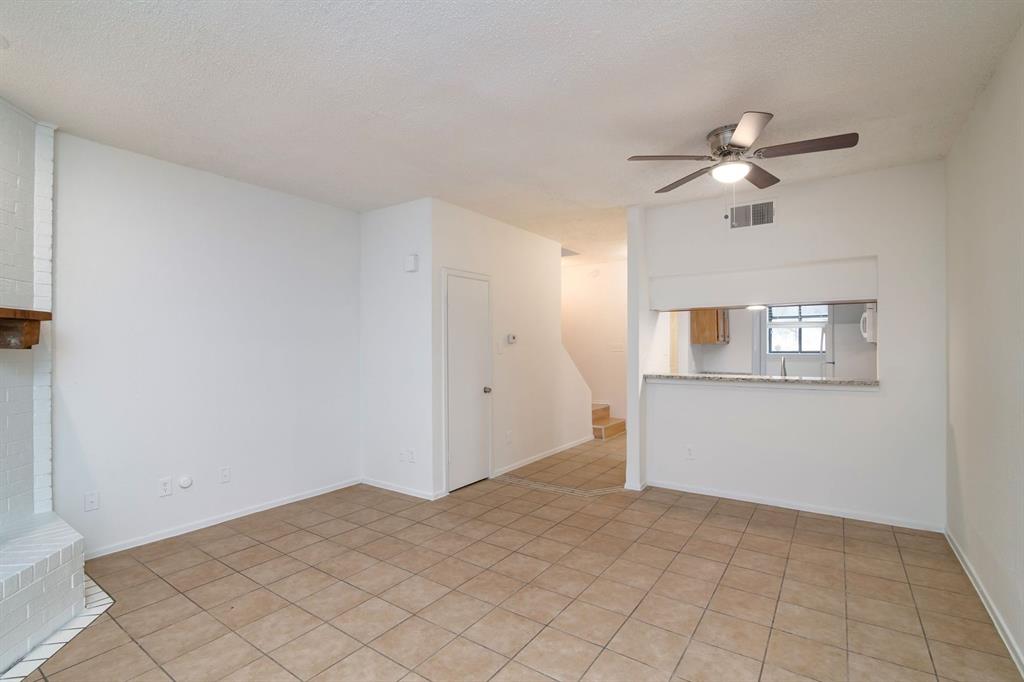 1445 Weiler Boulevard, Unit 1431 Fort Worth, TX 76112 - Photo 7 of 15 a view of a room with a ceiling fan and a window