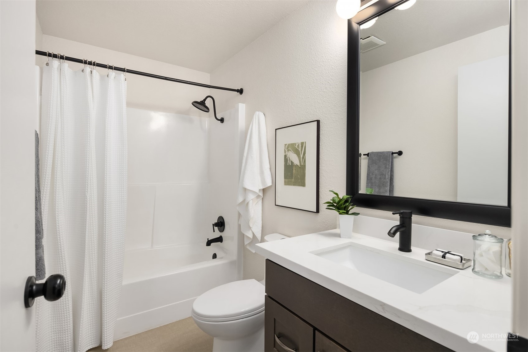 22830 Atlas Road Bothell, WA 98021 - Photo 15 of 40 a bathroom with a sink a toilet a mirror a vanity and shower