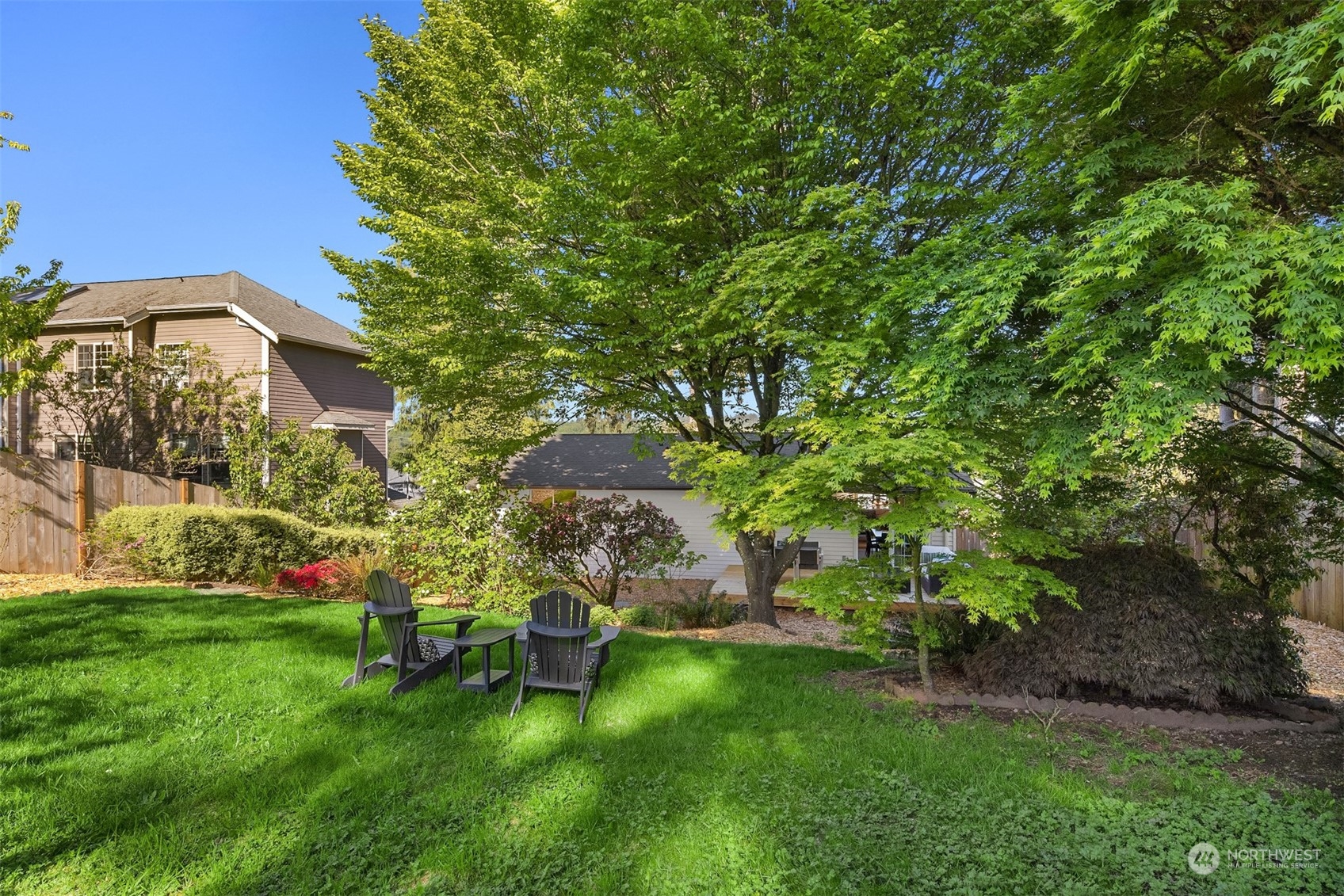 22830 Atlas Road Bothell, WA 98021 - Photo 34 of 40 a view of a backyard with table and chairs and potted plants