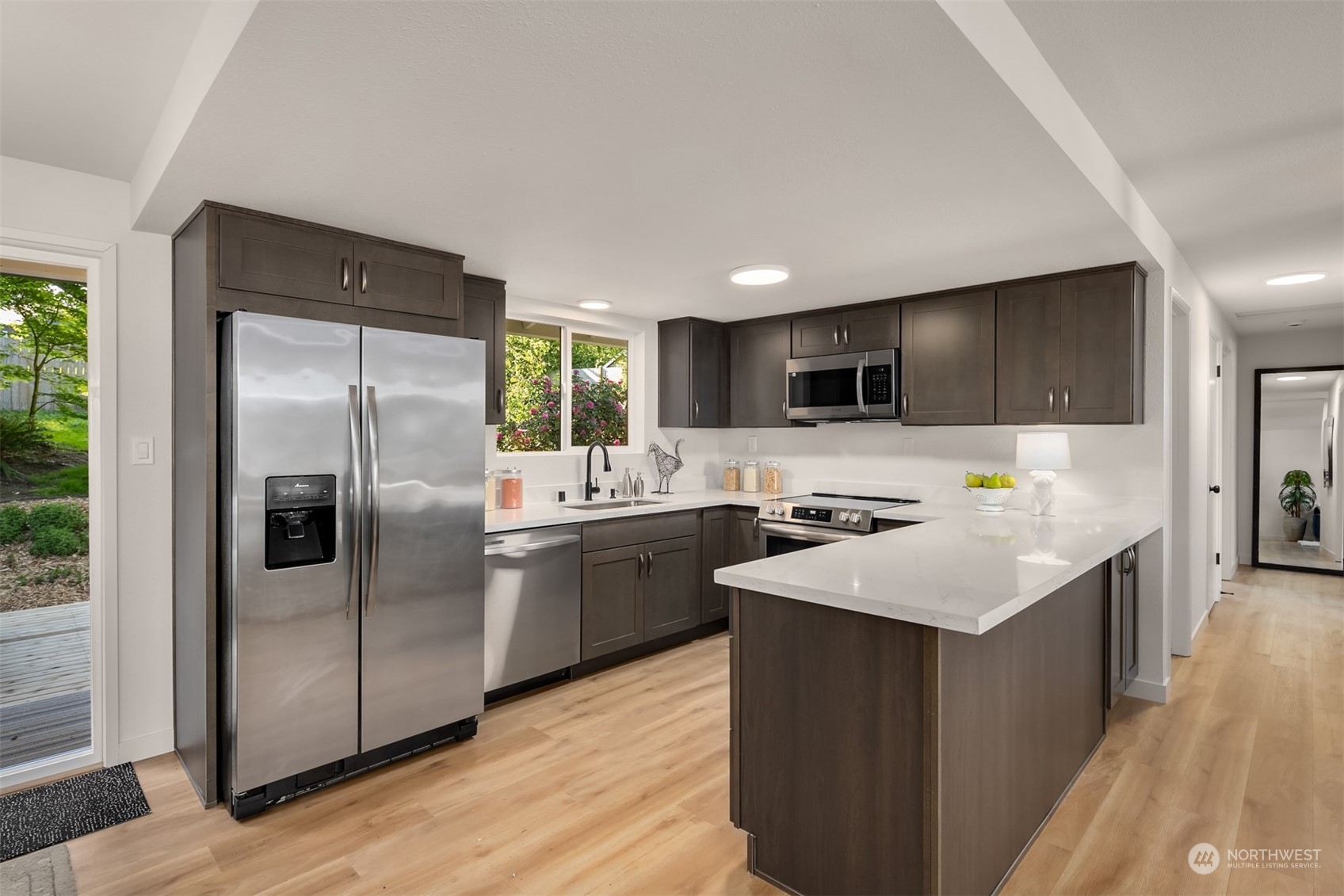 22830 Atlas Road Bothell, WA 98021 - Photo 10 of 40 a kitchen with stainless steel appliances granite countertop a refrigerator a sink a stove a microwave and island