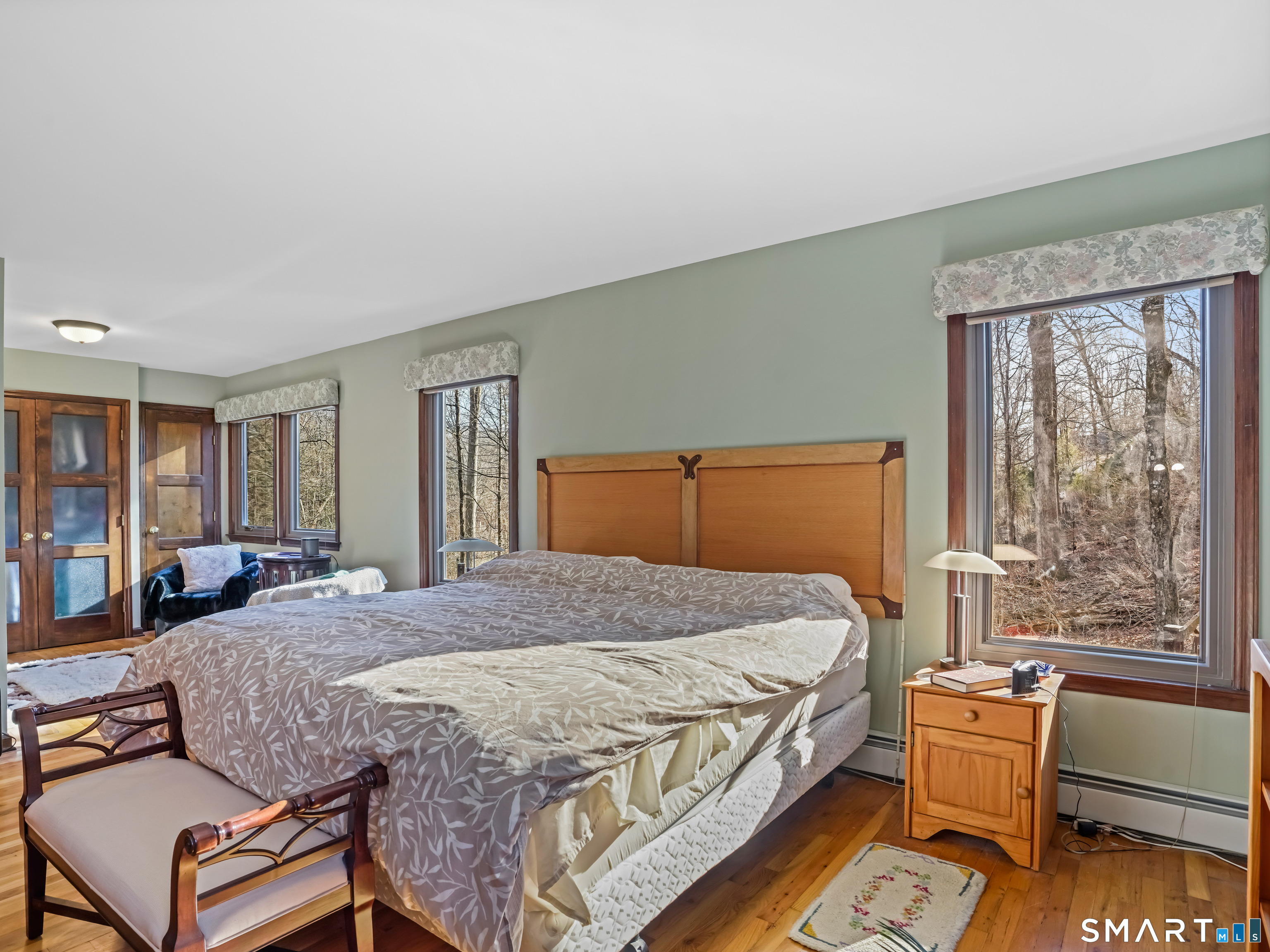 208 Cascade Road Stamford, CT 06903 - Photo 19 of 31 a bedroom with a bed and wooden floor